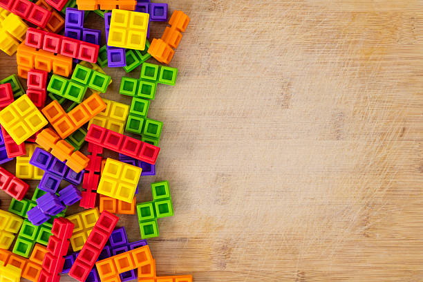 Colorful Interlocking Tower Blocks with Blank Space for Text on Wooden Background
