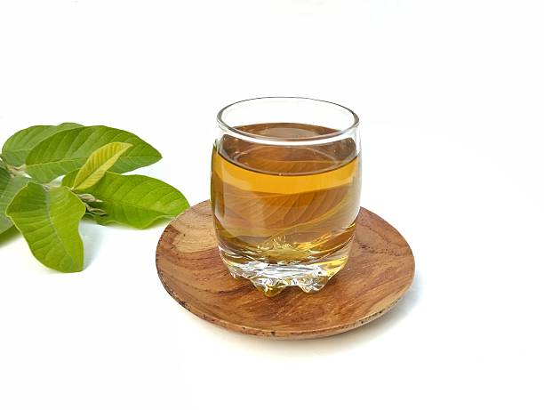 istock Guava leaf boiled water in glass isolated on white background 2219123894
