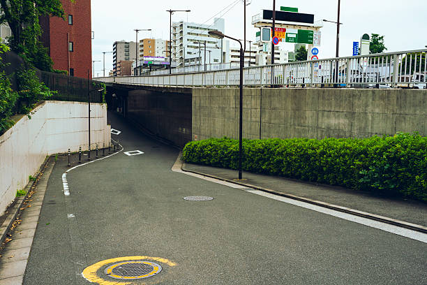 Small downhill walkway connecting to a city side road