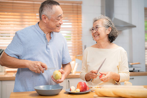 istock Seniors sharing a joyful moment while preparing a healthy meal in a modern kitchen during the afternoon 2219124859