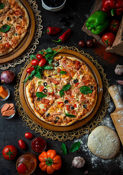 istock A pizza loaded with vegetables and cheese, Classic dramatic pizza scene 2219125266