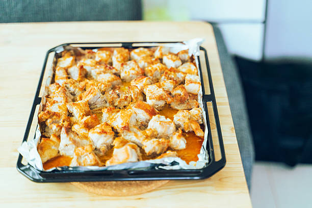 Assorted grilled meats: chicken and pork sizzling on open flame
