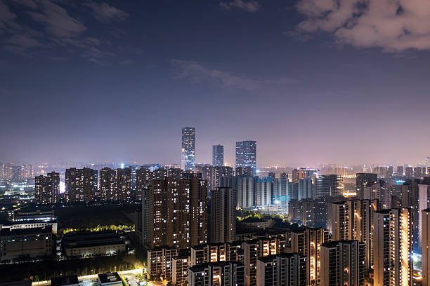 Bird view at Nanchang China. Skyscraper under construction in foreground. Fog, overcast sky and pollution. Bund (Nanchang) area