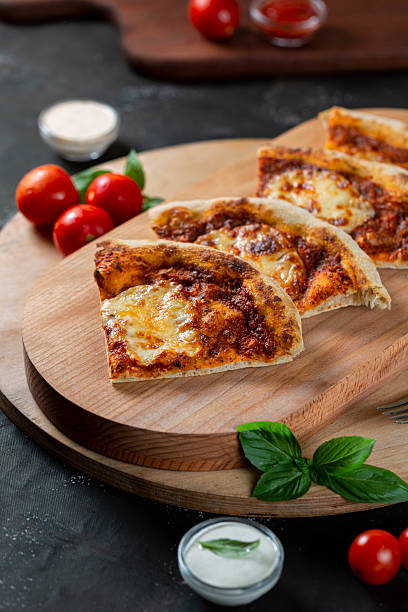istock Margherita pizza with sauce and melted cheese 2219126131
