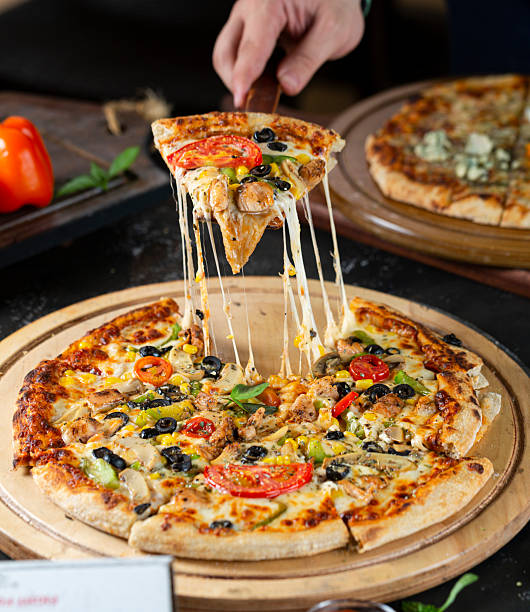 istock Stretching melted cheese on authentic Italian pizza 2219126153