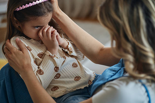 Mother consoling her daughter stock photo