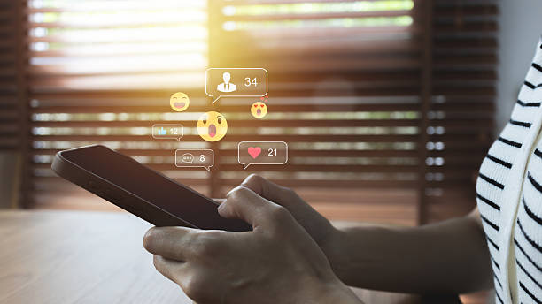 istock Young woman Using Smartphone with Multiple Social Media Notifications Displayed on Screen, Engaging in Digital Communication and Social Networking, Busy Lifestyle with Technology Interaction. 2219128255