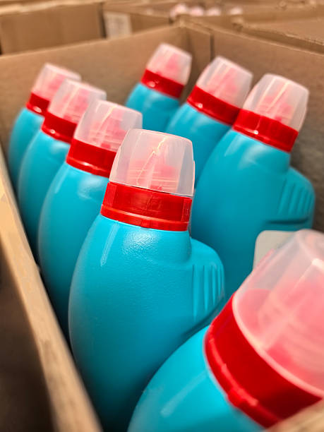 istock Bright blue cleaning bottles arranged neatly in a cardboard box 2219132144
