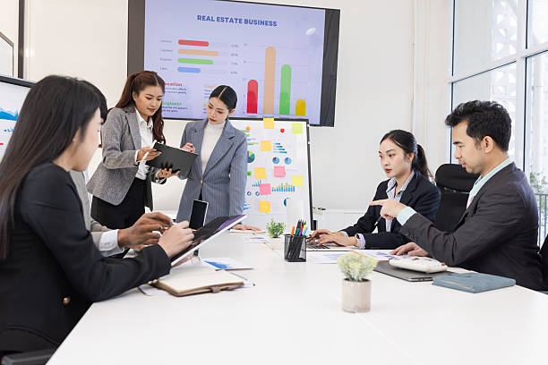 istock Group of business people working together with dashboard analysis and data management in meeting room. 2219132563