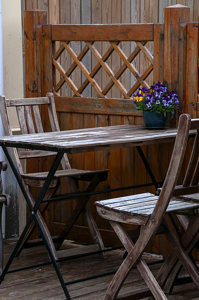 istock Small wooden table and chairs on patio 2219132572