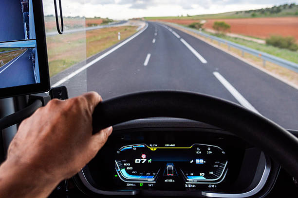 istock Truck dashboard screen while driving on a highway, showing speed and engine RPM data focused on fuel efficient driving. 2219132590