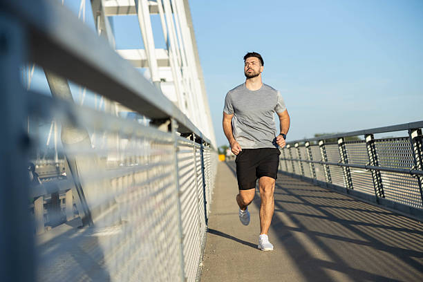 istock Jogging man enjoying morning sunlight 2219132769