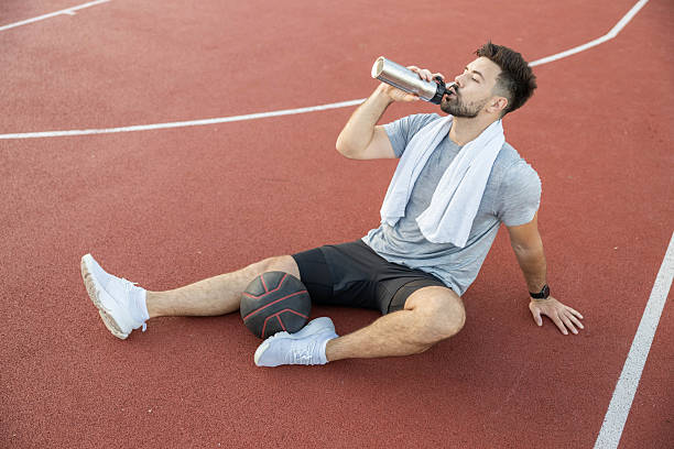 istock Exhausted Athlete Hydrating After Workout 2219132779