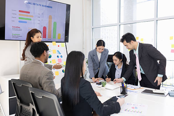 istock Group of business people working together with dashboard analysis and data management in meeting room. 2219133092