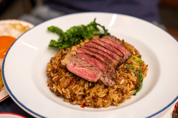 istock Stir-fried Basil with Rare beef steak served on plate. It is a popular Thai dish known as Pad Kra Pao 2219134035