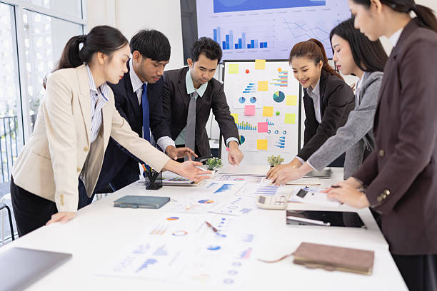 istock Group of business people working together with dashboard analysis and data management in meeting room. 2219134291