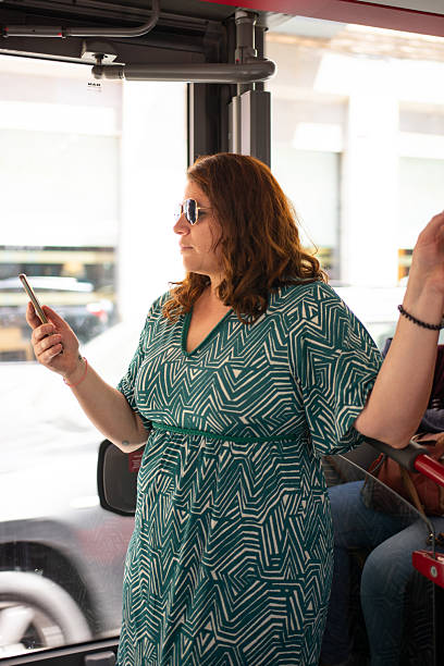 istock Woman using smartphone while riding bus in city 2219134435