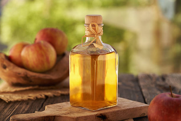 istock Apple cider vinegar in a glass bottle with fresh apples 2219134580