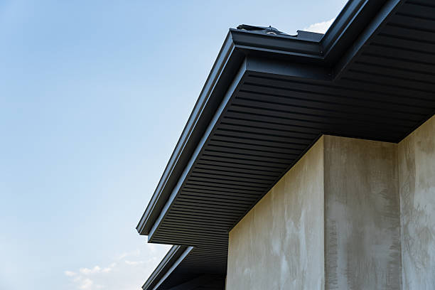 istock A close view of a metallic tile roofing installation on a modern building, showcasing craftsmanship and design under a bright sky 2219139242