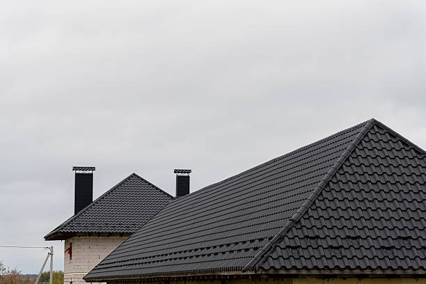 istock Metallic tiles cover rooftops, providing durability and style to new construction during overcast weather conditions 2219139292