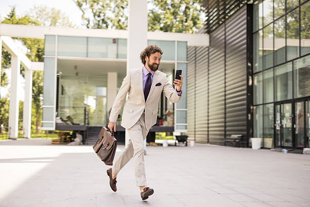 istock Modern businessman rushing to work with briefcase and phone 2219142538