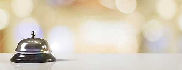 istock Hotel service bell on reception counter with blurred light background and empty copy space for hospitality or office design template concept. 3D Rendering 2219143928