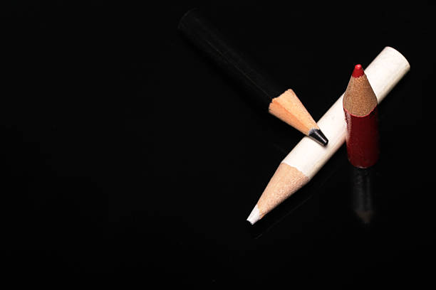 Colorful pencils on a dark, shiny surface spark creativity.