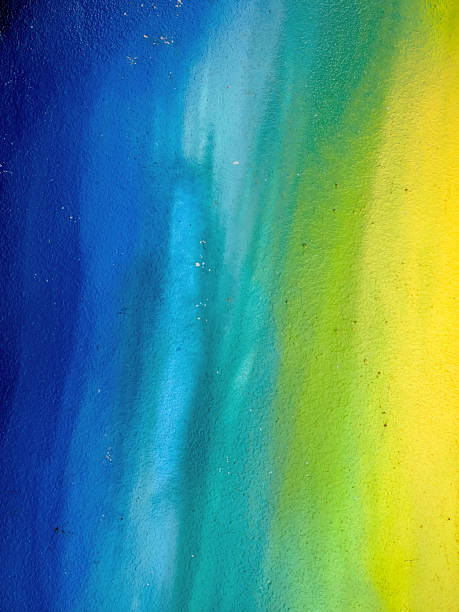 istock Painted wall with a color gradient from blue to yellow as a background 2219144354