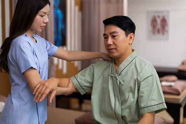 istock Physical therapist working with patient.Passive movement exercises for upper extremity .Doctor consulting with patient arm problems Physical therapy concept. 2219147100