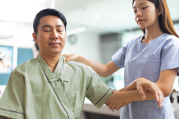 istock Physical therapist working with patient.Passive movement exercises for upper extremity .Doctor consulting with patient arm problems Physical therapy concept. 2219147121