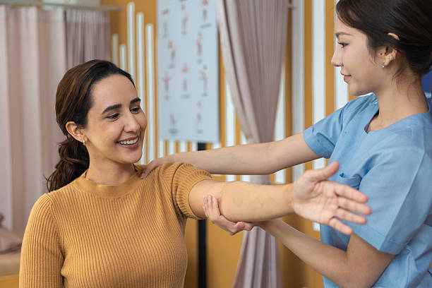 istock Physical therapist working with patient.Passive movement exercises for upper extremity .Doctor consulting with patient arm problems Physical therapy concept. 2219147125