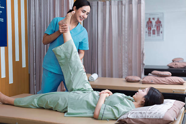 istock Physical therapist working with patient.Passive movement with stretching exercises for lower extremity .Doctor consulting with patient Knee or leg  problems Physical therapy concept. 2219147156