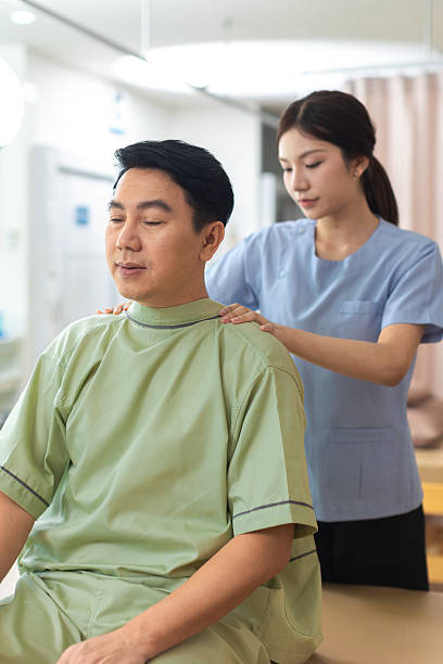 istock Physical therapist working with patient.Passive movement exercises for upper extremity .Doctor consulting with patient arm problems Physical therapy concept. 2219147466