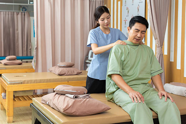 istock Physical therapist working with patient.Passive movement exercises for upper extremity .Doctor consulting with patient arm problems Physical therapy concept. 2219147468