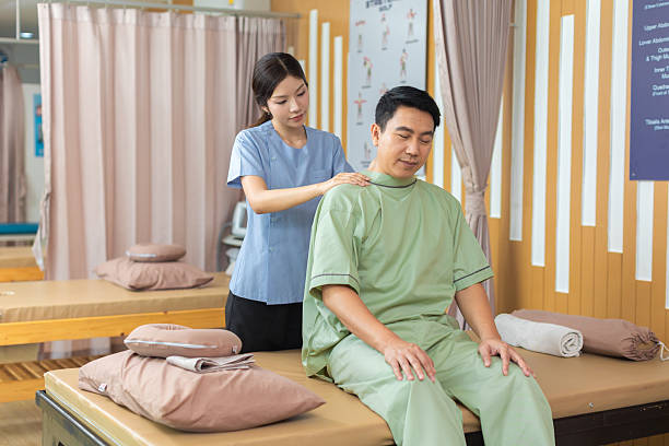 istock Physical therapist working with patient.Passive movement exercises for upper extremity .Doctor consulting with patient arm problems Physical therapy concept. 2219147473