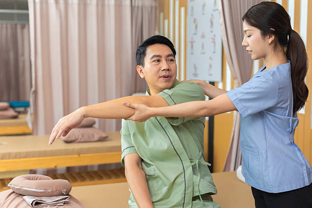 istock Physical therapist working with patient.Passive movement exercises for upper extremity .Doctor consulting with patient arm problems Physical therapy concept. 2219147525