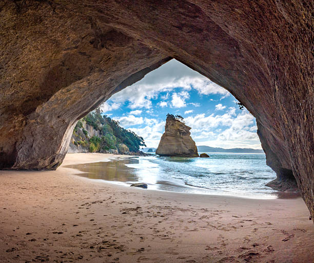 Reaching the secluded Cathedral Cover Beach with its famous Te Hoho Rock sea stack, Cathedral Cove, Mercury Bay Marine Reserve, Coromandel Peninsula, Noirth Island of New Zealand
