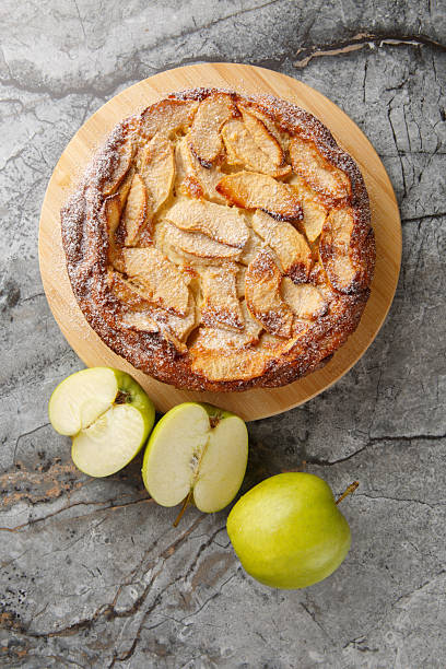 Apple Clafoutis is a delightful French-inspired dessert that combines tender, caramelized apples with a rich custard-like batter close-up. Vertical top view