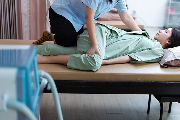 istock Physical therapist working with patient.Passive movement with stretching exercises for lower extremity .Doctor consulting with patient Knee or leg  problems Physical therapy concept.vertical video. 2219149161