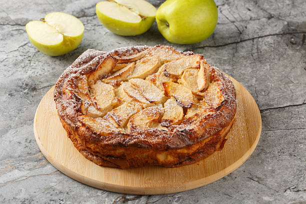 Apple Clafoutis is a delightful French-inspired dessert that combines tender, caramelized apples with a rich custard-like batter close-up. horizontal