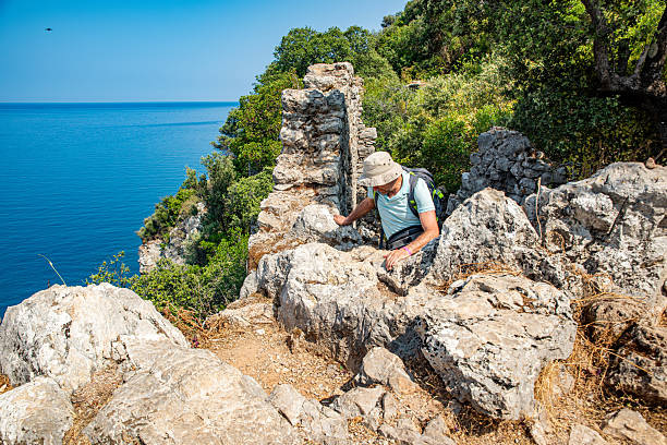 A man climbing the historical path on Mount Olympos