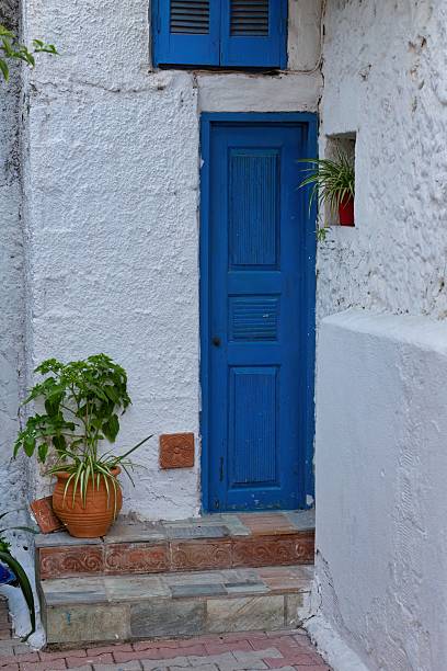 istock A vibrant blue door stands out against a white building 2219150548