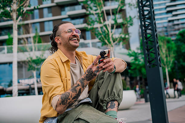 istock A young man in an urban setting smiling as he looks at his smartphone screen 2219150683