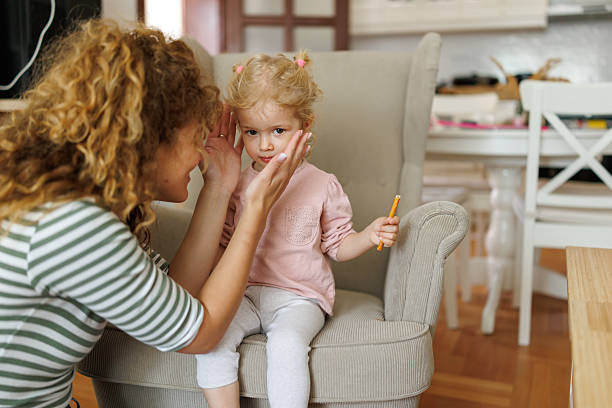 istock Happy mother caresses her daughter's face at home 2219150740