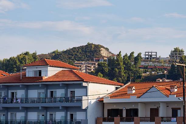 istock A cityscape shows buildings with red-tiled roofs under a partly cloudy sky 2219150759