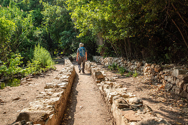 A man walking on the historical water path on Mount Olympus