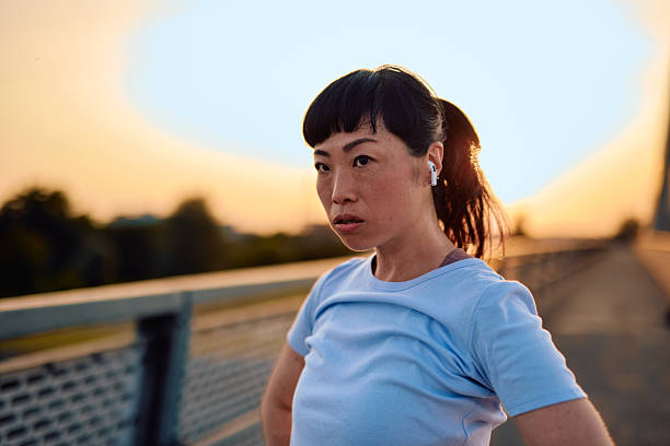 istock Determined sportswoman taking a break during her evening workout on a bridge 2219154915