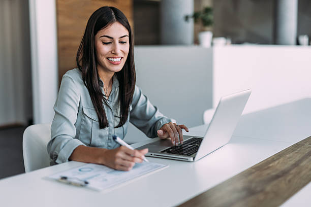 istock Successful businesswoman in modern office working on laptop. 2219155281
