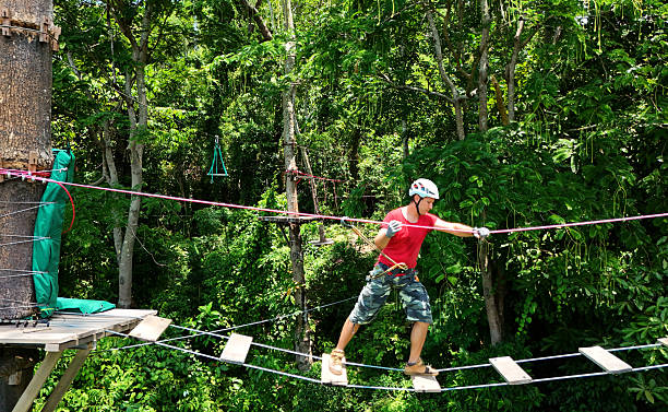 istock A man is walking across a challenging ropes course in the extreme park 2219156745