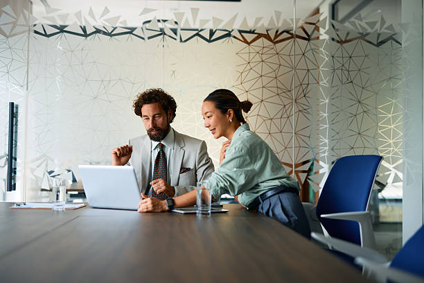 istock Business partners working together using laptop in modern office 2219159028